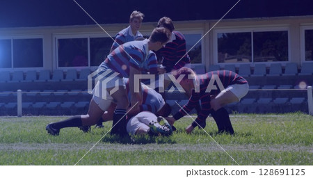 Image of spots lights moving over diverse team of rugby players during game in field Image of spots lights moving over diverse team of rugby players during game in field 128691125