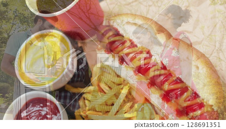 Image of diverse people making barbecue over hot dogs Image of diverse people making barbecue over hot dogs 128691351