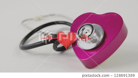 Image of heart with heart rate floating over stethoscope on white surface 128691389