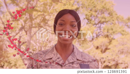 Image of hearts over happy african american female soldier 128691391