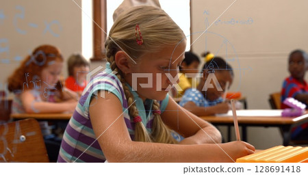 Image of math formulas over happy caucasian girl learning at school 128691418