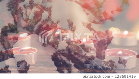 Image of candles over winter coniferous trees with snow 128691419