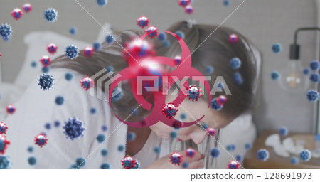 Leaning mature woman holding tissue over bed in bedroom, with viruses and biohazard symbol 128691973