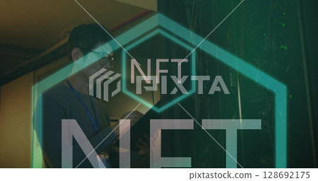 Image of nft text over asian male worker in server room 128692175