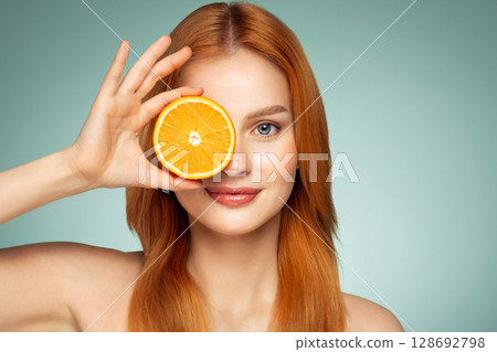 Red-haired woman posing with orange slices 128692798