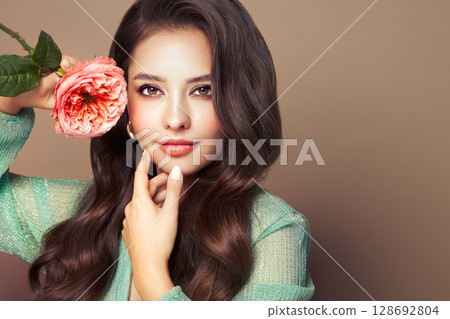 Beautiful young woman a rose flower Beautiful young woman a rose flower 128692804