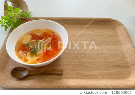 Chinese-style tomato and egg soup served in a white bowl Chinese-style tomato and egg soup served in a white bowl 128693005