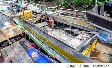 Close-Up of Traditional Wooden Fishing Boat with Gear and Engine on Tropical River 128693663