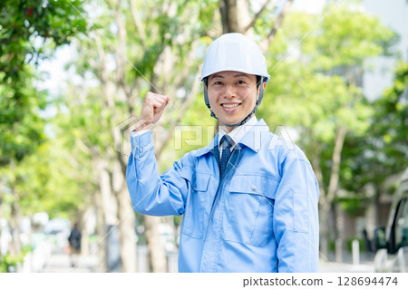 Middle-aged man in work clothes, fist pump 128694474