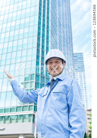 Middle-aged man in work clothes waving his hands 128694566