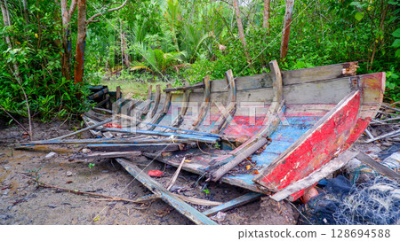 Wrecked Wooden Boat Abandoned in Muddy Tropical Mangrove Forest 128694588