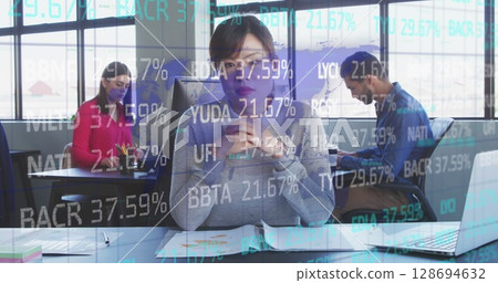 Image of financial data over asian businesswoman working in office 128694632