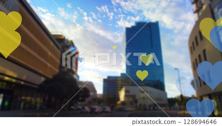 Image of yellow and blue hearts floating over cityscape 128694646