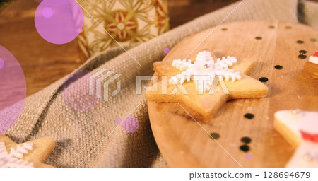 Image of purple dots over cookies and christmas gift Image of purple dots over cookies and christmas gift 128694679
