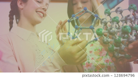 Image of mathematical equations over caucasian children with model in lab Image of mathematical equations over caucasian children with model in lab 128694796