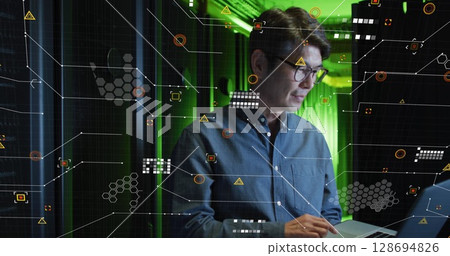 Image of data processing over asian male worker in server room Image of data processing over asian male worker in server room 128694826