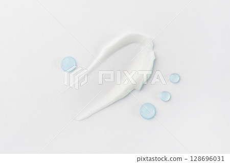 Smears and drops of cosmetics on a white background 128696031