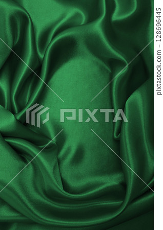 Smooth elegant green silk or satin luxury cloth texture as abstract background. Luxurious background design 128696445
