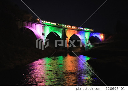 Kamaishi Line: Kiha 110 series diesel railcar crossing the colorfully lit Megane Bridge Kamaishi Line: Kiha 110 series diesel railcar crossing the colorfully lit Megane Bridge 128697401