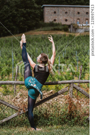 Ballerina Stretching Outdoors in a Vineyard Setting Ballerina Stretching Outdoors in a Vineyard Setting 128697413