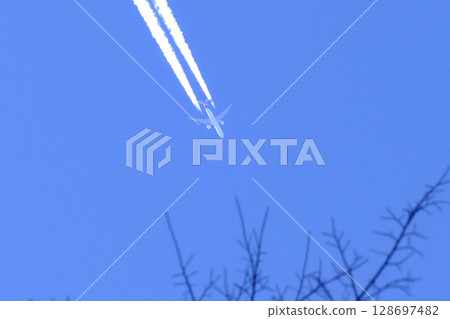 Landscape with contrails in the blue sky Landscape with contrails in the blue sky 128697482