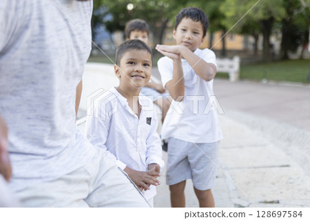 Latin american family enjoying time together in a park Latin american family enjoying time together in a park 128697584