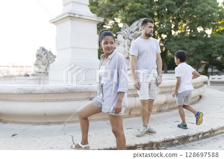 Family enjoying vacation posing by fountain in lisbon Family enjoying vacation posing by fountain in lisbon 128697588