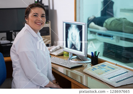 Radiologist Analyzing X-Ray Scans in a Medical Imaging Room. 128697665