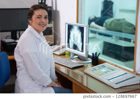 Radiologist Analyzing X-Ray Scans in a Medical Imaging Room. 128697667