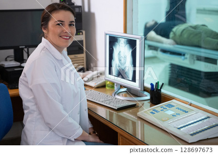 Radiologist Analyzing X-Ray Scans in a Medical Imaging Room. Radiologist Analyzing X-Ray Scans in a Medical Imaging Room. 128697673