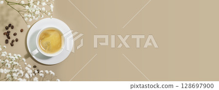 Coffee banner with cup of natural coffee and coffee beans on beige background with white flowers and shadows. Spring morning composition with cup of fresh hot espresso. Breakfast. Flat lay, copy space Coffee banner with cup of natural coffee and coffee beans on beige background with white flowers and shadows. Spring morning composition with cup of fresh hot espresso. Breakfast. Flat lay, copy space 128697900
