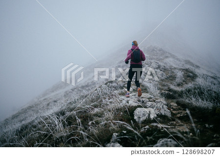 Trail Runner in Misty Mountain Landscape Trail Runner in Misty Mountain Landscape 128698207