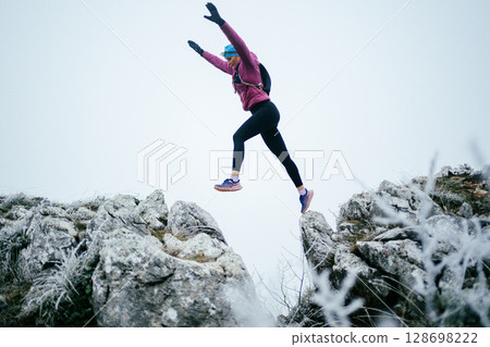 Trail Runner in Misty Mountain Landscape Trail Runner in Misty Mountain Landscape 128698222