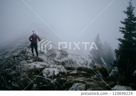 Trail Runner in Misty Mountain Landscape 128698224