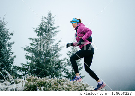 Trail Runner in Misty Mountain Landscape Trail Runner in Misty Mountain Landscape 128698228
