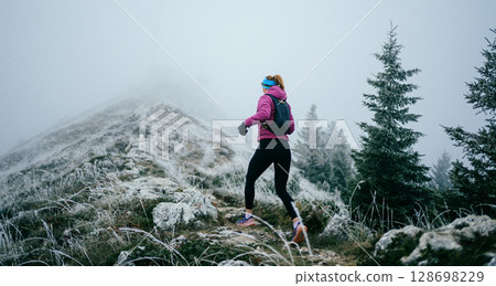 Trail Runner in Misty Mountain Landscape 128698229