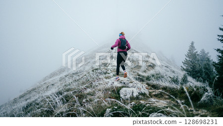 Trail Runner in Misty Mountain Landscape Trail Runner in Misty Mountain Landscape 128698231