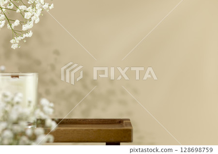 Wooden empty podium for beauty or spa products, cosmetics on natural beige background with flowers and candle. Scene stage showcase for product, promotion sale or advertising. Front view, copy space Wooden empty podium for beauty or spa products, cosmetics on natural beige background with flowers and candle. Scene stage showcase for product, promotion sale or advertising. Front view, copy space 128698759