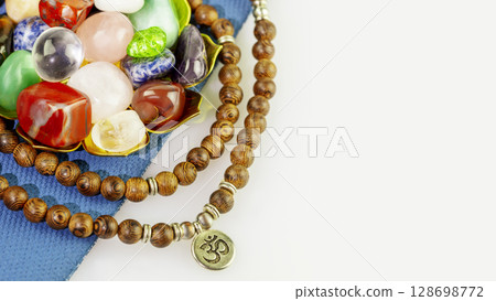 Crystals gemstones set with rosary beads on yoga mat on white background. Minerals for esoteric spiritual practice, Healing Crystal Ritual, Witchcraft, Relax Chakra. Reiki therapy, meditation concept Crystals gemstones set with rosary beads on yoga mat on white background. Minerals for esoteric spiritual practice, Healing Crystal Ritual, Witchcraft, Relax Chakra. Reiki therapy, meditation concept 128698772