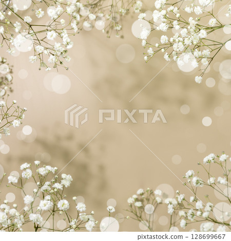 Spring flower background with branches of blossoming white gypsophila on beige background with bokeh effect. Spring time. Natural blossoming background. Soft focus Spring flower background with branches of blossoming white gypsophila on beige background with bokeh effect. Spring time. Natural blossoming background. Soft focus 128699667
