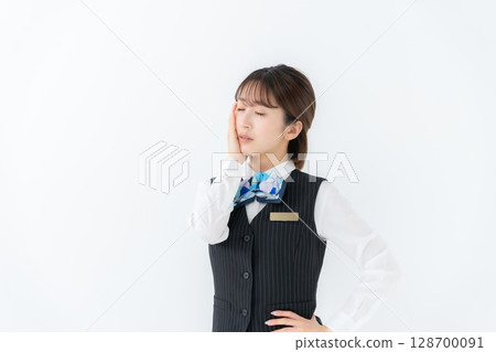 Young woman in uniform, business, worries 128700091