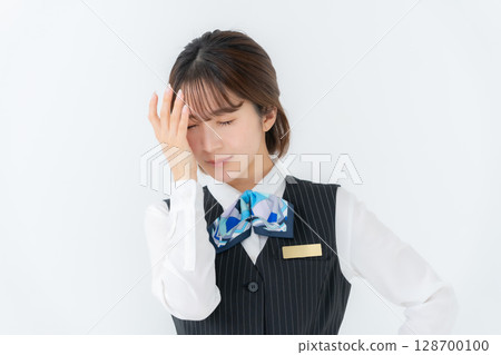 Young woman in uniform, business, eyestrain 128700100