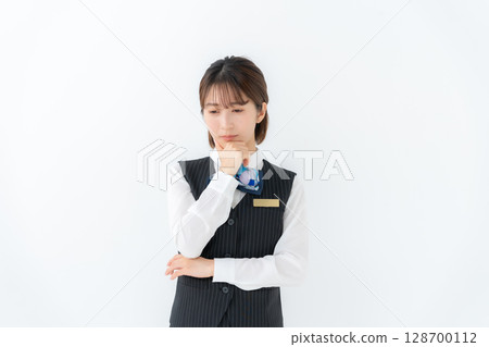 Young woman in uniform, business, worries Young woman in uniform, business, worries 128700112