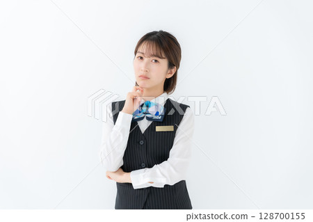 Young woman in uniform, business, worries 128700155