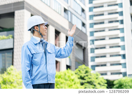 Middle-aged man in work clothes waving his hands 128700209