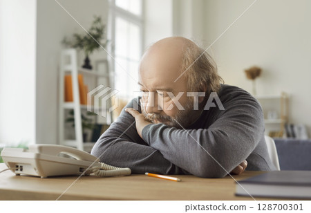 Ordinary Nervous Senior Man Waiting For Phone Call Ordinary Nervous Senior Man Waiting For Phone Call 128700301