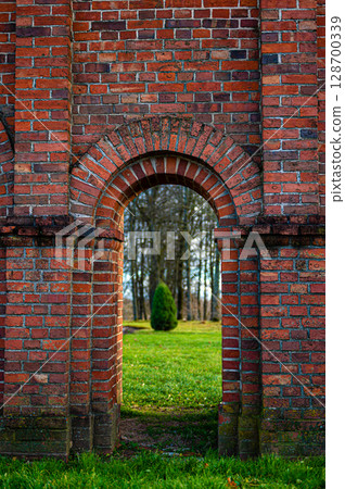 Old Catholic Church red brick gates in city Akniste, Latvia. Closeup 128700339