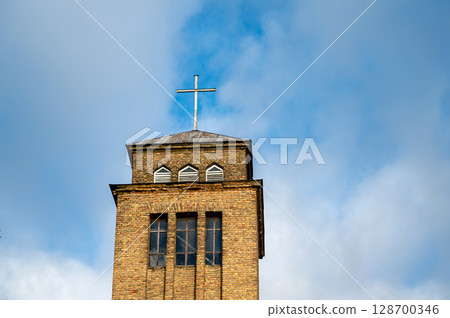 The bell tower of St. Ignatius Roman Catholic Church of Akn?ste on the background of the sky. 128700346