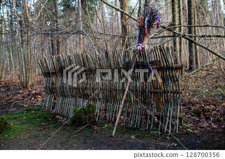A witchs broom by a branch fence in a fairy-tale, magical forest. A witchs broom by a branch fence in a fairy-tale, magical forest. 128700356