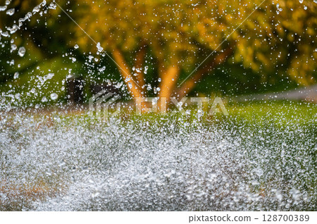water splash with small drops in fountain, abstract natural background, selective focus water splash with small drops in fountain, abstract natural background, selective focus 128700389